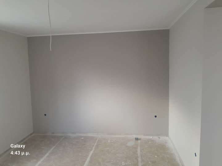 empty unfurnished room under construction with bare floor and painted walls